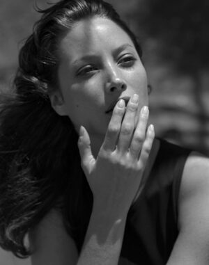 A woman with her hand over her mouth.