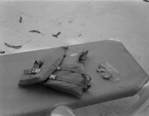 A bag and some papers on the ground.