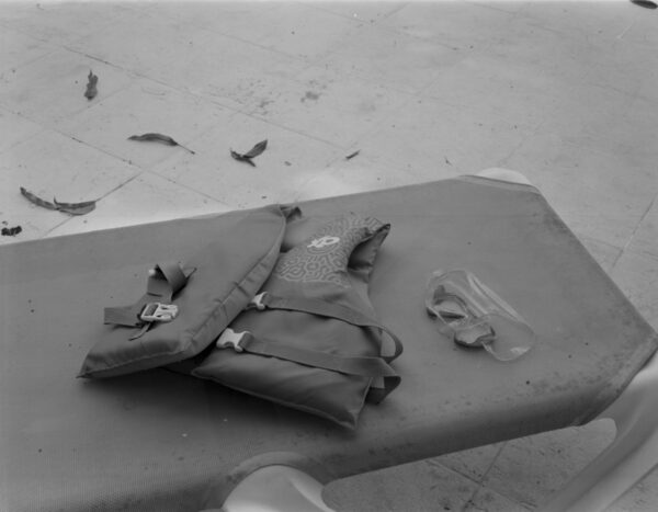 A bag and some papers on the ground.