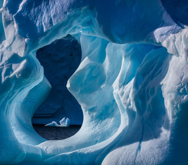 A blue cave with a person in it