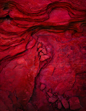 A red rock with some kind of heart on it