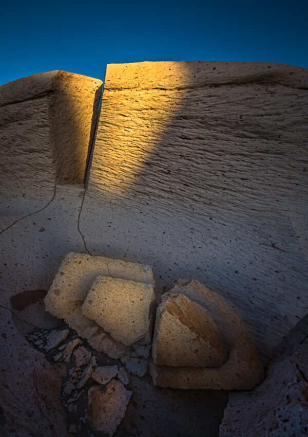 A stone wall with light shining on it.