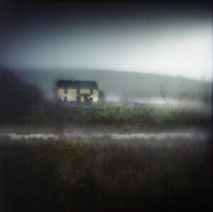 A blurry photo of a bus on the side of a road.