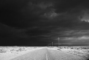 A black and white photo of an empty road