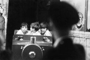 Three boys are sitting in a train car.