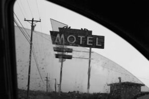 A motel sign is seen in the distance.