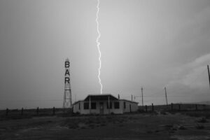 A lightning strike is seen in the sky above a bar.