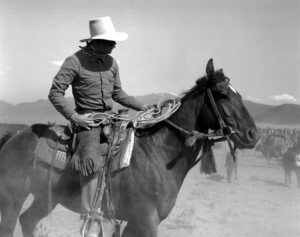 A man on horseback in the desert.