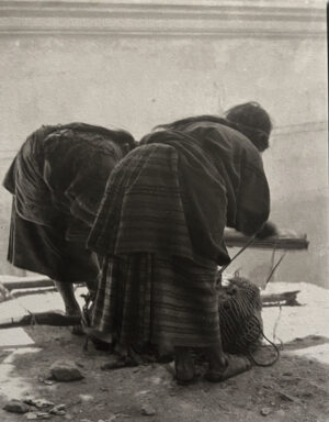 Two people in a blanket and holding poles