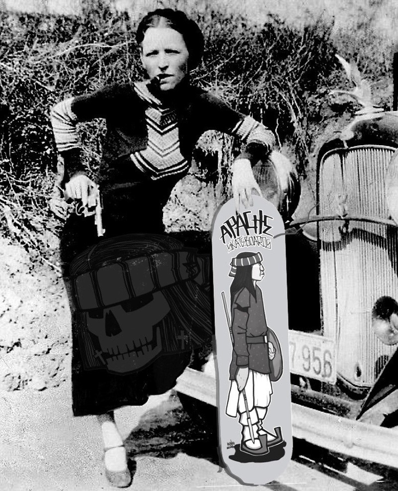 A woman and man sitting on the ground in front of a bench.