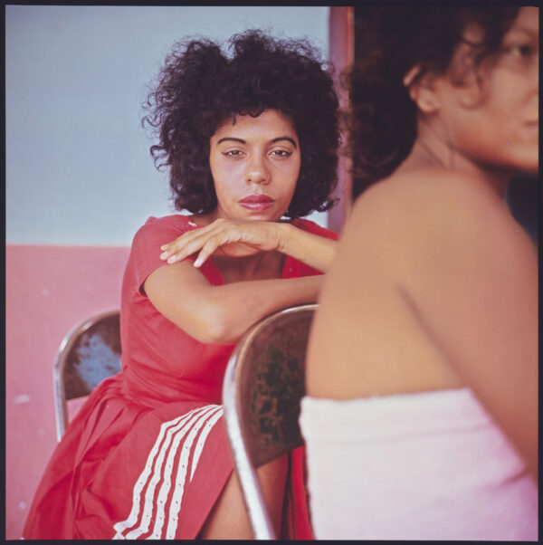 A woman sitting in front of another woman.