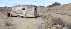 A rusted out trailer in the middle of nowhere.