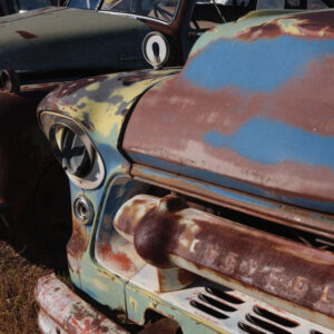 A close up of an old truck with rust on it