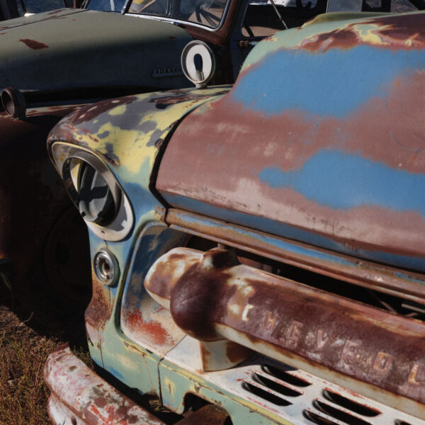 A close up of an old truck with rust on it