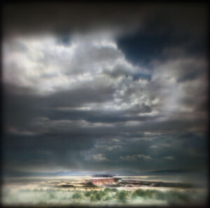 A cloudy sky with some clouds in the background