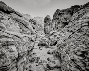 A black and white photo of rocks in the desert.
