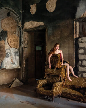A woman sitting on top of a couch in a room.