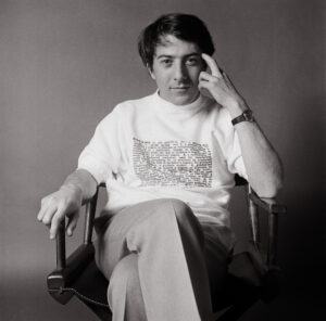 A man sitting in a chair with his hand on the head.