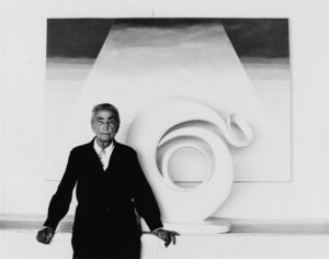 A man standing in front of an abstract painting.