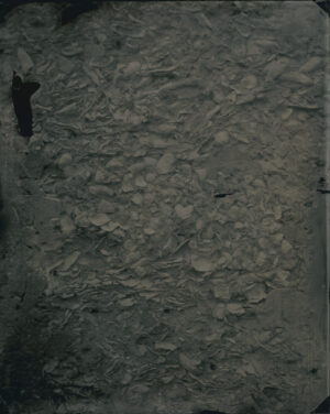 A black and white photo of a person standing on the ground.