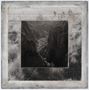 A black and white photo of a river in the middle of a valley.