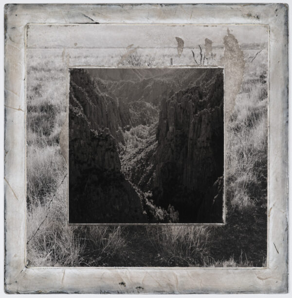 A black and white photo of a river in the middle of a valley.