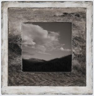 A black and white photo of the sky with clouds.