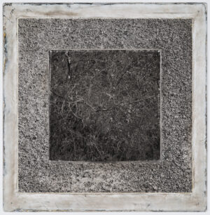 A square concrete slab with some type of frame.