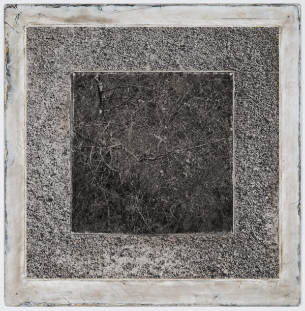 A square concrete slab with some type of frame.