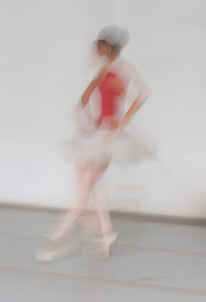A blurry image of a woman in a red dress