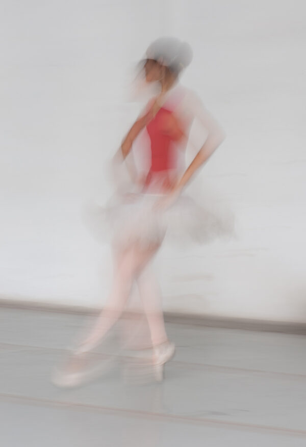 A blurry image of a woman in a red dress