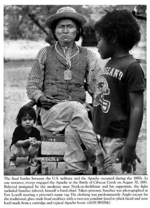 A woman sitting on top of a wooden bench next to two children.