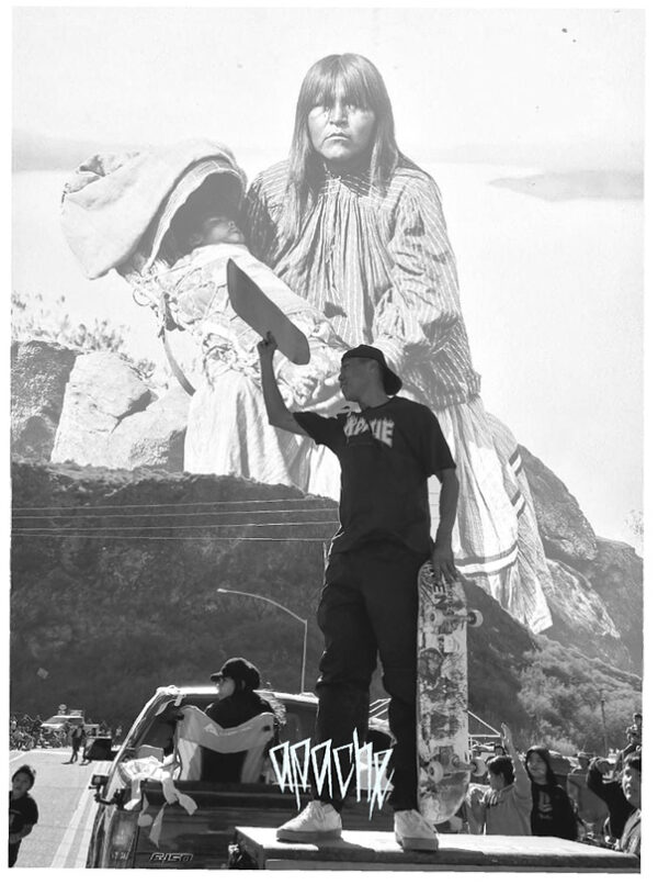 A man standing on top of a chair in front of a large statue.