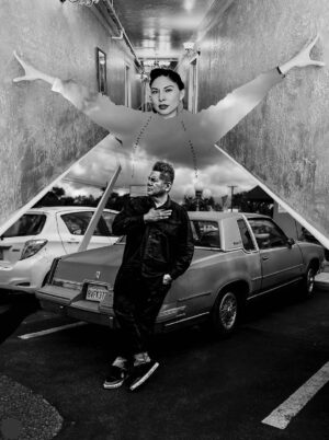 A man holding an umbrella in front of a car.