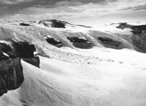 A black and white photo of snow covered hills.