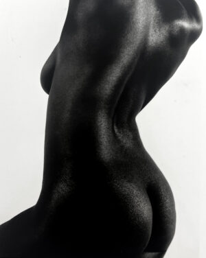 A black woman 's back and torso in the nude.
