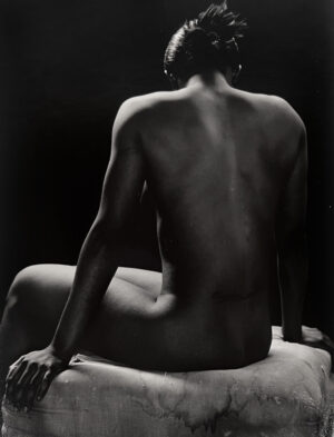 A man sitting on top of a white chair.