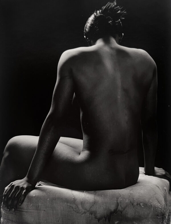 A man sitting on top of a white chair.