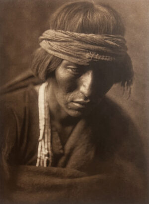 A man with a beard and head covering.