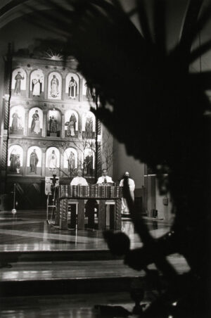 A black and white photo of a building with people in it.