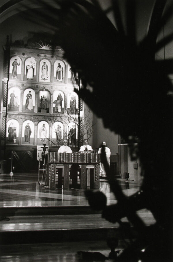 A black and white photo of a building with people in it.