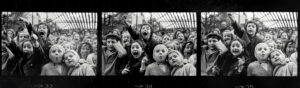 A group of children are standing in the crowd.