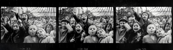 A group of children are standing in the crowd.