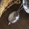 A necklace with a bird 's feather in it.