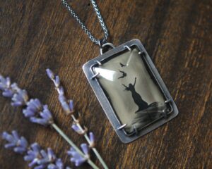 A necklace with a picture of a cat on it.