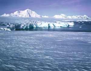 A large body of water with ice and snow on it.