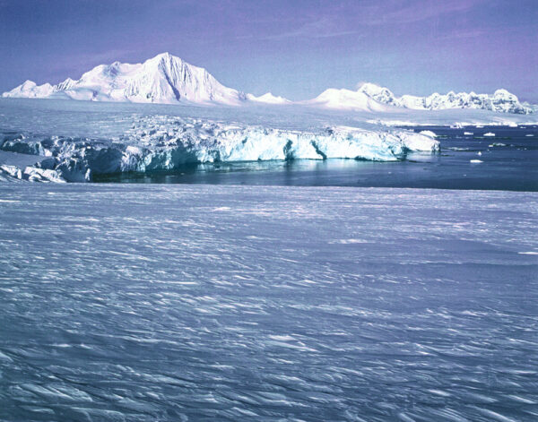 A large body of water with ice and snow on it.