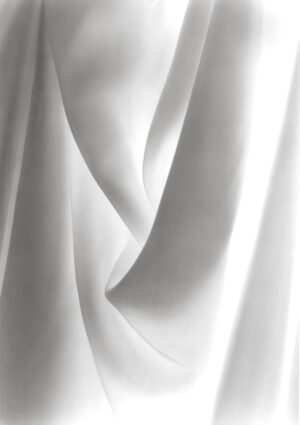A white cloth that is folded up and has some folds.