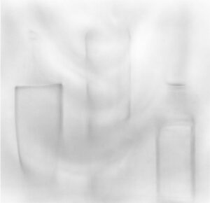 A blurry image of some white bottles and cups.