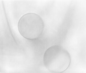 Two white balls are shown on a sheet.